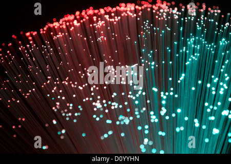 colorful illuminated plastic optical fibers in dark back Stock Photo