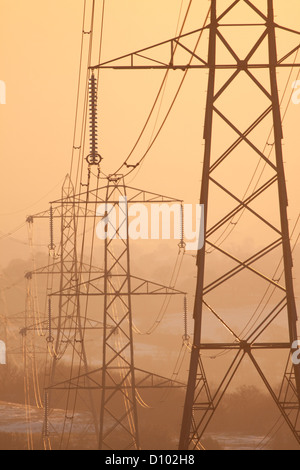 National Grid pylons on a misty morning, England, UK Stock Photo