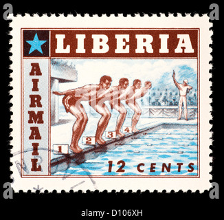 Postage stamp from Liberia depicting swimmers at the start of a race. Stock Photo