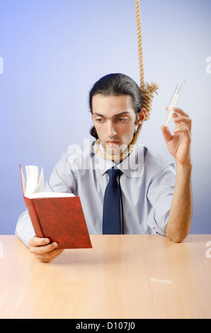 Man reading bible and taking drugs Stock Photo