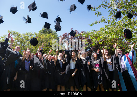 Graduates from the Engineering School of the University of Southampton, England, try to catch their mortar boards. Stock Photo