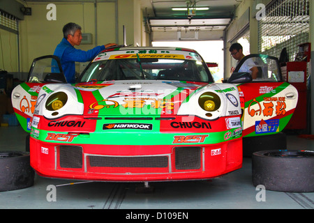 Hankook team mechanic working on their race car in the garage at Sepang circuit. Stock Photo