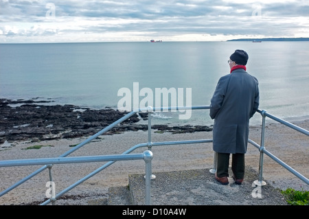 old man looks out to sea on a beach holiday in Sri Lanka. Picture taken ...