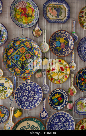 Decorative plates and Spoons on a wall Stock Photo