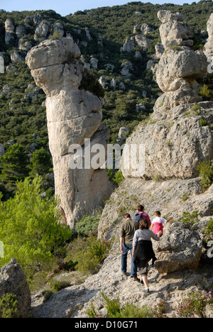 Dolomite rock columns,  people walking between them, Cirque de Moureze, Languedoc-Roussillon, France, Europe Stock Photo