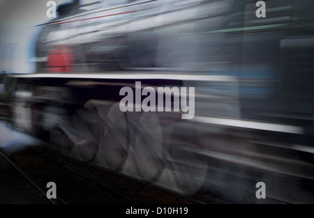 Classic vintage steam train racing passed with motion blur Stock Photo