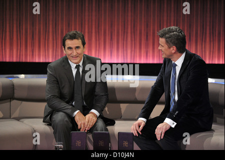 Italian raceing car driver and Olympic winner, Alessandro Zanardi (L), attends the annual review show 'Menschen 2012' (People of 2012) hosted by talk show host Markus Lanz (R) and aired on public television broadcasting station ZDF in Munich, Germany, 2 December 2012, Photo: Marc Mueller Stock Photo
