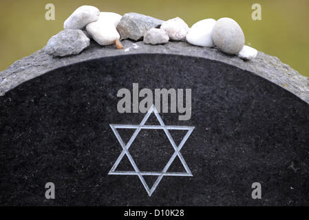 (dpa FILE) - An archive picture, dated 12 June 2009, shows the Star of David engraved on the tomb stone of Anne Frank at the Bergen-Belsen memorial site near Lohheide, Germany. The lack of public awareness in Germany concerning the crimes committed by the Nazi regime was common at the time when the former Bergen-Belsen concentration camp was founded as a memorial site 60 years ago. Since then, more than eight million people have visited the site where more than 70 000 prisoners of war and concentration camp prisoners where murdered. Photo: Peter Steffen Stock Photo