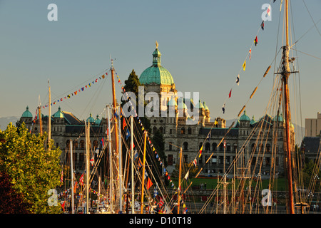 Victoria Inner Harbour and Parliament buildings  at dusk with masts of Classic Boats, Victoria, British Columbia BC, Canada Stock Photo