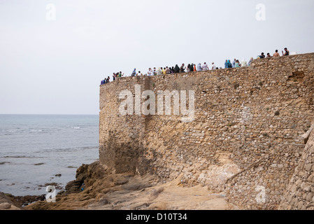 People enjoying the view off the fortified walls of Asilah Stock Photo