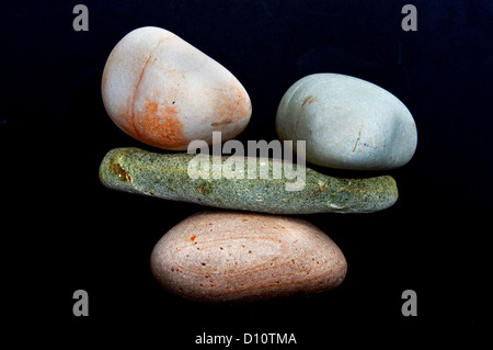 four water washed stones balanced to act as scales. four water washed stones balanced to act as scales.