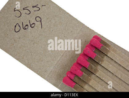 Close view of a matchbook with a generic phone number on a white background. Stock Photo