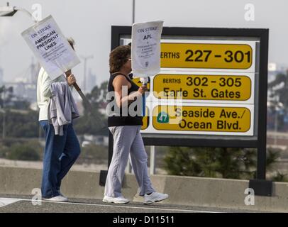 Dec. 4, 2012 - Los Angeles, California (CA, United States - Striking workers walk with a picket outside the Port of Los Angeles Tuesday December 4, 2012 in Los Angeles, California. The strike was launched last Tuesday by the 800-member International Longshore and Warehouse Union Local 63 Office Clerical Unit, which had been working without a contract since June 30, 2010. With some 10,000 ILWU members honoring the strikers' picket lines, the action has shut down 10 of the 14 cargo container terminals at the complex. At least 11 ships have diverted cargo to other ports, including in Mexico, sinc Stock Photo