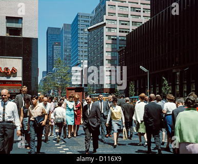 1960s PEDESTRIANS CROSSING NEW YORK CITY STREET CORNER OF 42ND STREET AND THIRD AVENUE EAST SIDE MANHATTAN Stock Photo