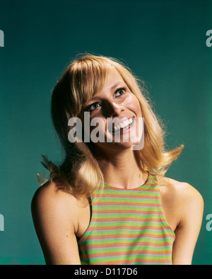 1960s PORTRAIT OF YOUNG BLOND WOMAN SMILING WEARING STRIPED SLEEVELESS TOP Stock Photo