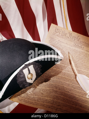 1970s PATRIOTIC STILL LIFE OF AMERICAN FLAG TRICORN HAT AND CONSTITUTION WITH QUILL PEN Stock Photo