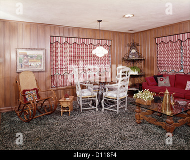 1960s 1970s LIVING ROOM INTERIOR SHAG WALL TO WALL CARPET BENTWOOD ROCKER RED STRIPE ROMAN SHADES Stock Photo