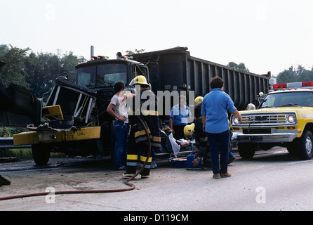 1970s TRAFFIC ACCIDENT COLLISION INVOLVING TRUCK EMERGENCY RESPONDERS ON SITE Stock Photo
