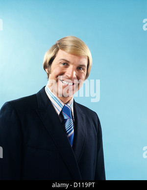 1960s 1970s PORTRAIT SMILING BUSINESSMAN IN SUIT AND TIE WITH BOND HAIR IN COMB OVER STYLE Stock Photo