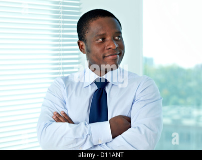 Portrait of African businessman looking aside in office Stock Photo