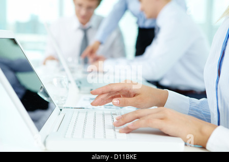Close-up of female hands typing on the laptop keyboard Stock Photo