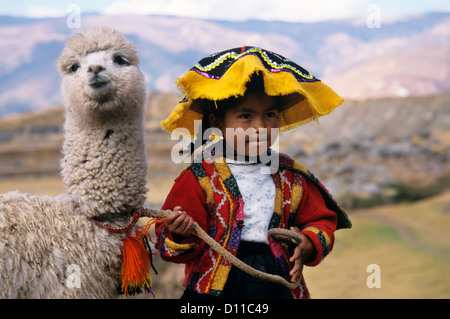 CUZCO PERU QUECHUA INDIAN GIRL WITH BABY LLAMA Stock Photo