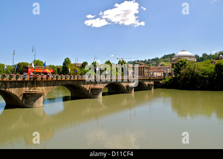 Bridge on river in flood in a sunny day in Turin with Gran Madre church on background. Stock Photo