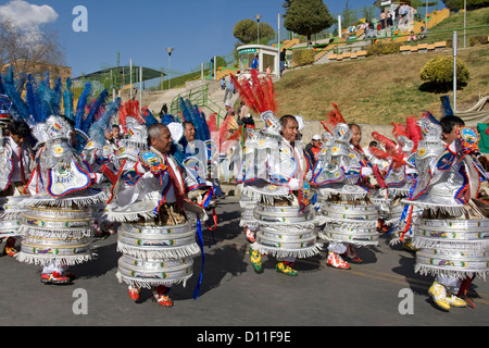 Group of indigenous men dressed in traditional costume dancing in street carnival in city of La Paz, Bolivia South America Stock Photo