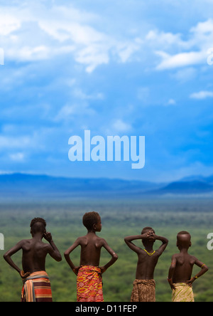 Rear View Of Karo Tribe Kids Looking At The Landscape, Korcho Village, Ethiopia Stock Photo