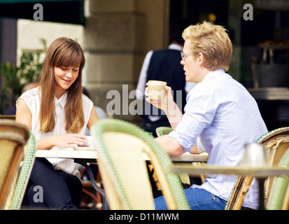 Young couple in a coffee shop talking over a cup of coffee Stock Photo