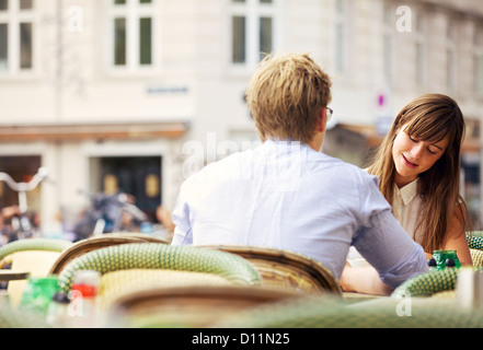 Casual woman having a conversation with her date in an open air restaurant Stock Photo