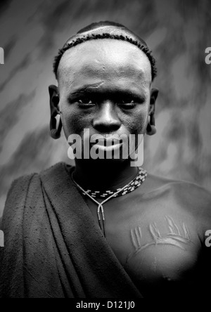 Black And White Portrait Of A Surma Tribe Warrior With Scarifications, Omo Valley, Ethiopia Stock Photo