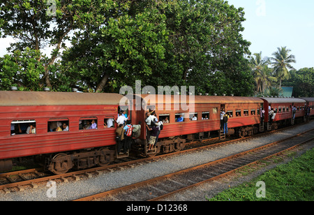Crowded morning commuter train passes Mount Lavinia on the way to Colombo. Stock Photo