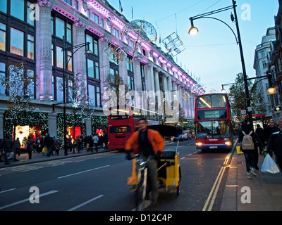 Traffic on Oxford Street showing Selfridges Department store at night, City of Westminster, London, England, United Kingdom Stock Photo