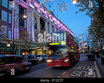 Traffic on Oxford Street showing Selfridges Department store at night, City of Westminster, London, England, United Kingdom Stock Photo