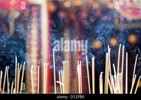 Incense left burning by worshipers at Wong Tai Sin Temple. Also known as Sik Sik Yuen Wong Tai Sin Temple in Hong Kong Stock Photo