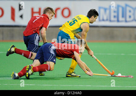 06.12.2012 Melbourne, Australia. Trent Mitton of Australia attempts to evade Mark Gleghorne and Henry Weir of England during the Men's Hockey Champions Trophy from the State Netball Hockey Centre. Stock Photo