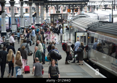People waiting to board an East Coast Main Line train at York Railway Station, England. Stock Photo