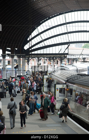 People waiting to board an East Coast Main Line train at York Railway Station, England. Stock Photo