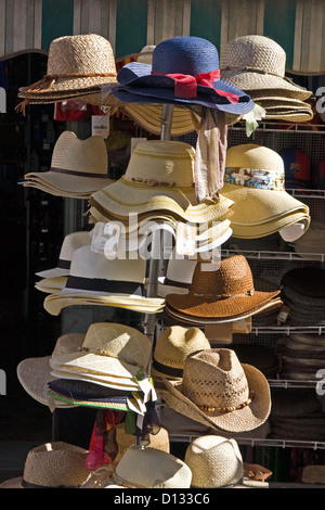 Women's and men's straw hats on a beach lounger with sunglasses. Summer ...