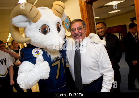 US Secretary of Defense Leon Panetta poses with Bill the Goat, the US Naval Academy Midshipmen mascot during a pep rally held in the halls of the Pentagon December 6, 2012. The 113th Army Navy football game will be held this Saturday in Philadelphia. Stock Photo