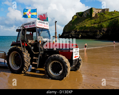 Tractor used to transport passengers to boat from Caldey Island to Tenby on Castle Beach in Tenby Pembrokeshire Wales UK Stock Photo