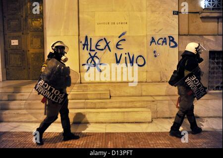 Athens, Greece. 6th December 2012. Two police officers stand in front of the Banque de Grece during the protests on the fourth anniversary of the death of 15 year old Alexandros Grigoropoulos in Athens Greece on 06.12.2012. Alexandros Grigoropoulos was killed on 06.12.2008 at the age of 15 years by a bullet from a police weapon. Stock Photo