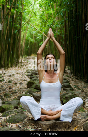 Hawaii, Maui, Kipahulu, Woman Meditating In Bamboo Forest. Stock Photo