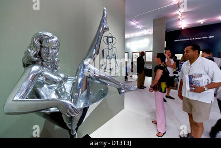 Dec. 06, 2012 - Miami Beach, Florida, US - Artist Mel Ramos' polished aluminum work, 'Dita,' draws stares  at the 11th Annual Art Basel Miami Beach.  More than 260 galleries from around the globe are exhibiting art by thousands of artists over the course of the fair's five-day run.(Credit Image: © Brian Cahn/ZUMAPRESS.com) Stock Photo