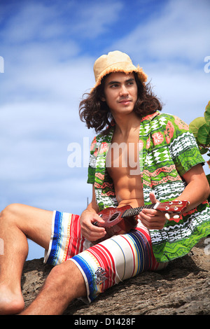 Hawaii, Oahu, Young Male With Vintage Aloha Shirt And Straw Hat Relaxing Holding A Ukulele. Stock Photo