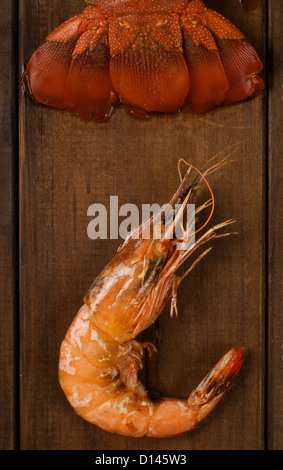 Freshly looked crayfish tail and prawn on wooden table Stock Photo