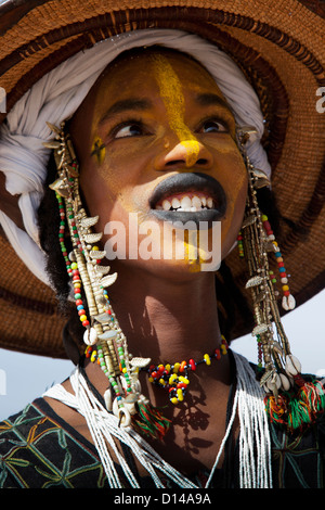 Man from Wodaabe nomadic tribe painting face - Stock Image - C055/0222 -  Science Photo Library