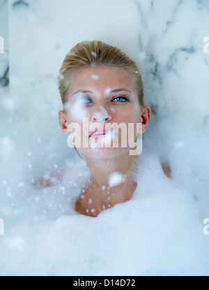 Woman playing in bubble bath Stock Photo