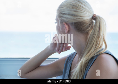 Woman looking out window Stock Photo